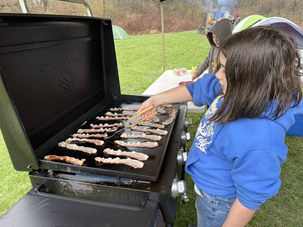 Scout cooking at camp